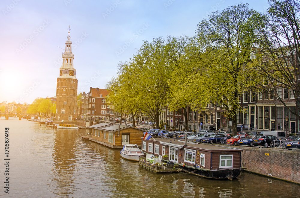 Street cityscape in Amsterdam, Netherlands, Europe. Canal and Church at sunrise