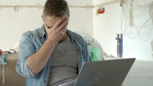 Man looks worried while working on the project, steadycam shot
