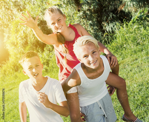 Laughing kids running on grass © JackF