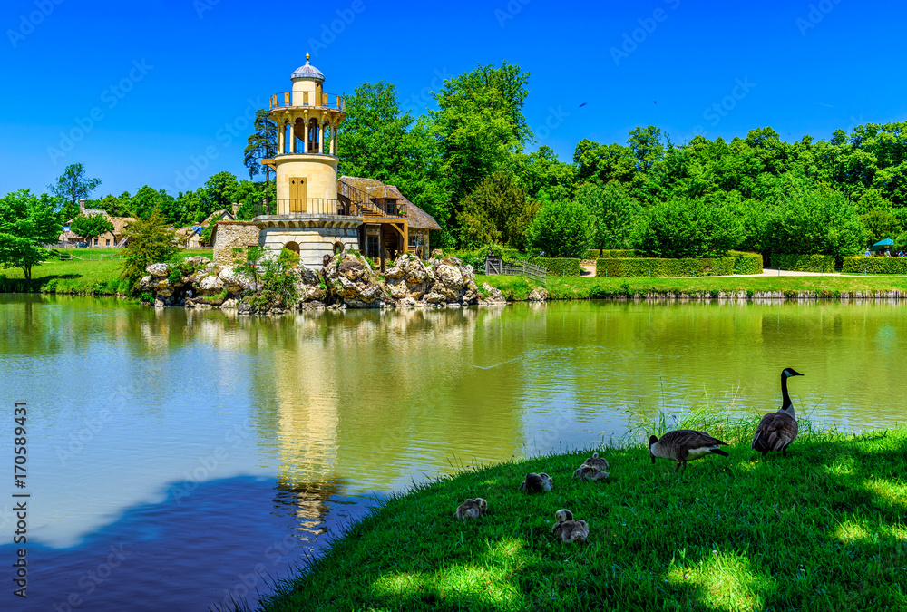 Fototapeta premium Marlborough Tower in The Hameau de la Reine (The Queen s Hamlet) is a rustic retreat in the park of the Chateau de Versailles built for Marie Antoinette in 1783 near the Petit Trianon, France