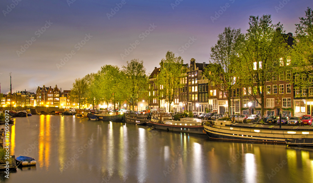 Beautiful evening landscape on the canal in Amsterdam, Netherlands, Europe.
