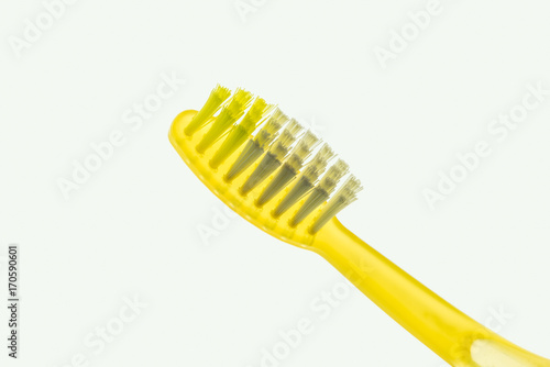 Backlit yellow toothbrush isolated on a white background