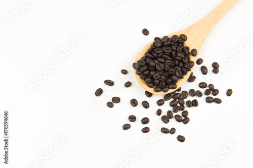 Close up coffee bean on wooden spoon on white background. high angle view. copy space background