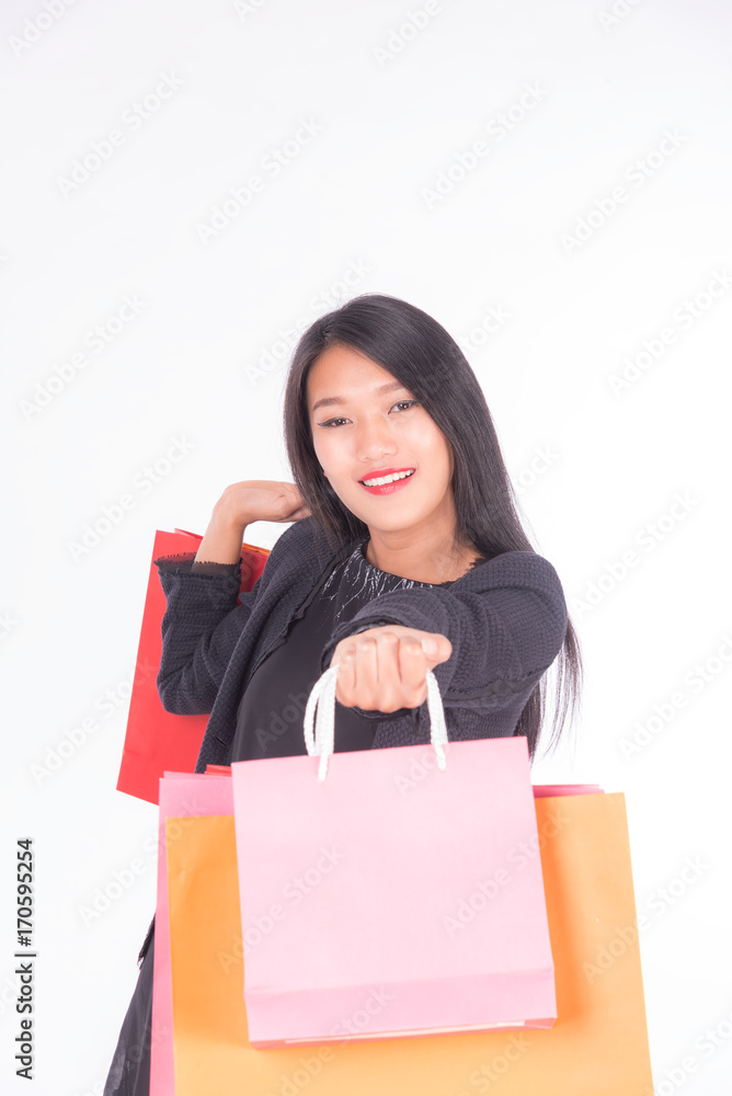 Cheerful shopping women of Asian holding bags with smart-phone isolated on white ,portrait beautiful business women in studio Cheerful shopping women of Asian holding bags with smart-phone isolated on white ,portrait beautiful business women in studio