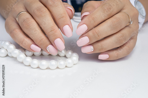 Amazing natural nails. Women's hands with clean manicure. Gel polish applied.