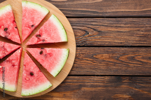 watermelon slices on dark wooden background top view