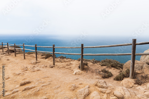 Old wooden railings on the edge of Cabo da Roca © evannovostro