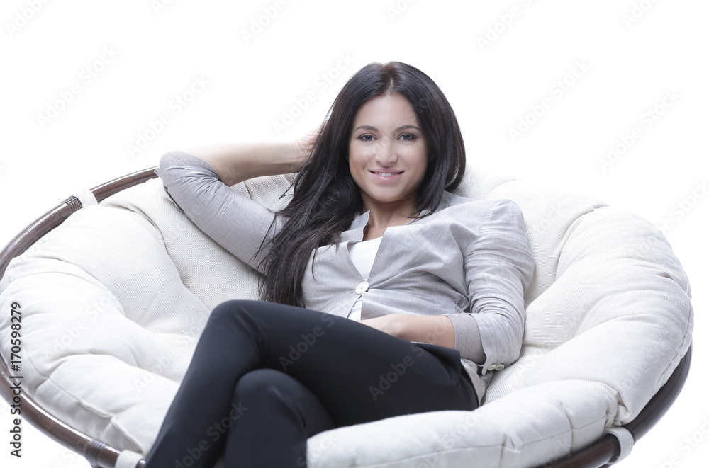 young woman sitting in a comfortable soft big armchair young woman sitting in a comfortable soft big armchair