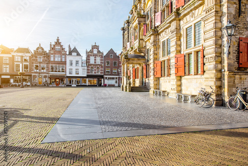 View on the Town hall and beautiful buildings on the central square during the sunny morning in Delft city, Netherland