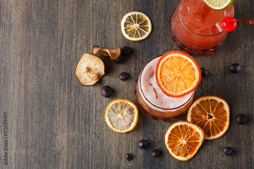 Blood orange margarita cocktail at wooden background