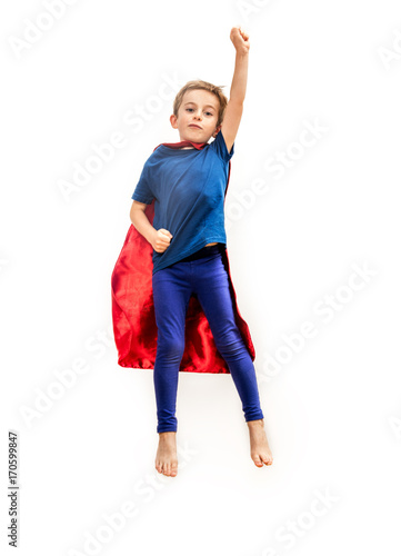 Принти на полотні Isolated superhero boy with cape pretending gripping freedom over white
