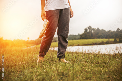 Asian women relax in the holiday. Walking foot on the meadow