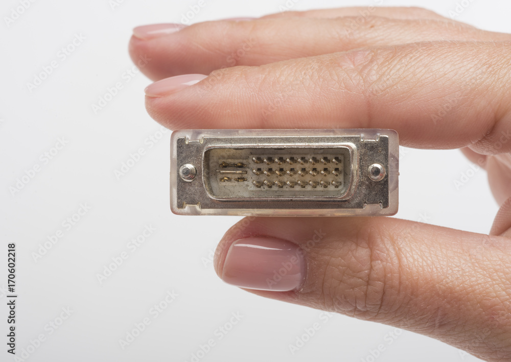 Female hand holding DVI connection cable isolated on white background Female hand holding DVI connection cable isolated on white background