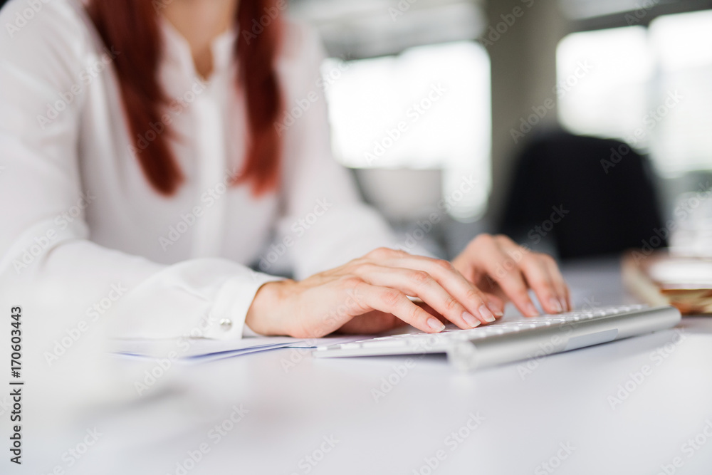 Unrecognizable businesswoman in the office writing something. Unrecognizable businesswoman in the office writing something.