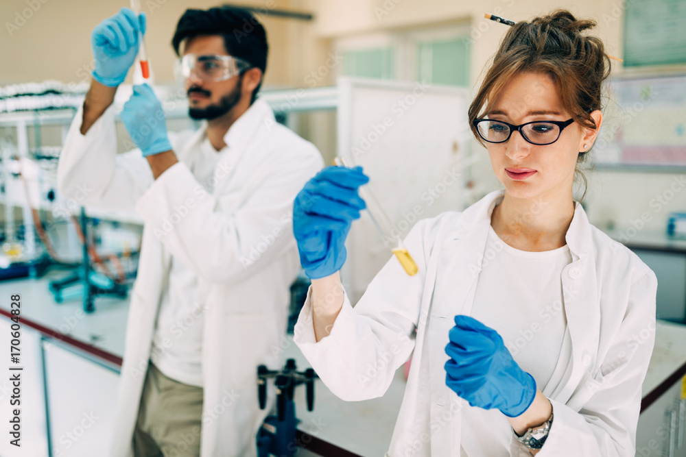 Young students of chemistry working in laboratory Young students of chemistry working in laboratory
