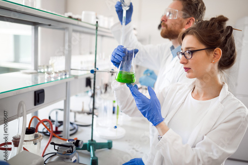 Young students of chemistry working in laboratory