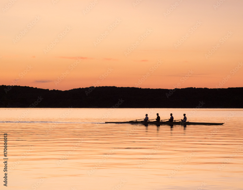 rowing on the sea at sunset