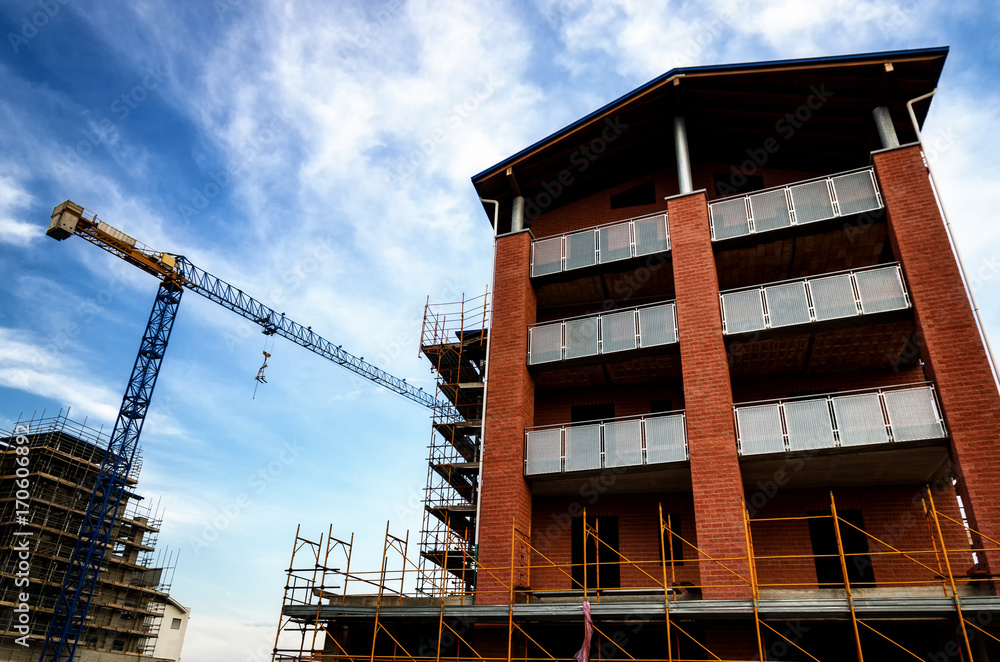 Building construction work yard with crane and clouds Building construction work yard with crane and clouds