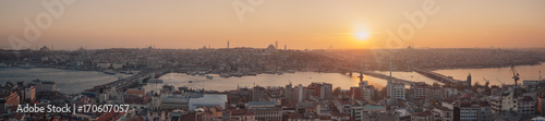 Istanbul sunset panorama - Turkey travel background. Extra wide panoramic photo of Istanbul, Turkey. Autumn cityscape with Golden Horn, shot taken from the viewpoint of Galata tower