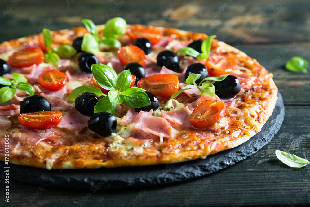 Pizza on a thin dough with olives and fresh basil Pizza on a thin dough with olives and fresh basil