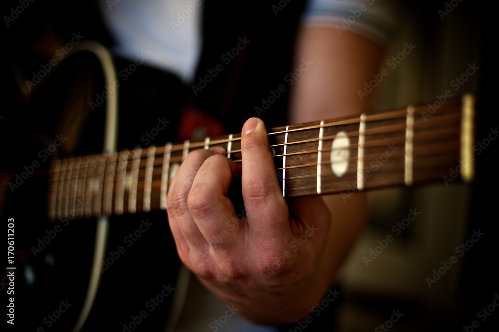 Closeup of a man's hand playing a chord on an acoustic guitar. Closeup of a man's hand playing a chord on an acoustic guitar.