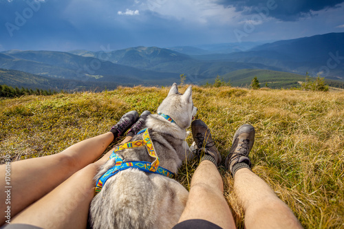 Legs of traveler sitting mountain in travel dog
