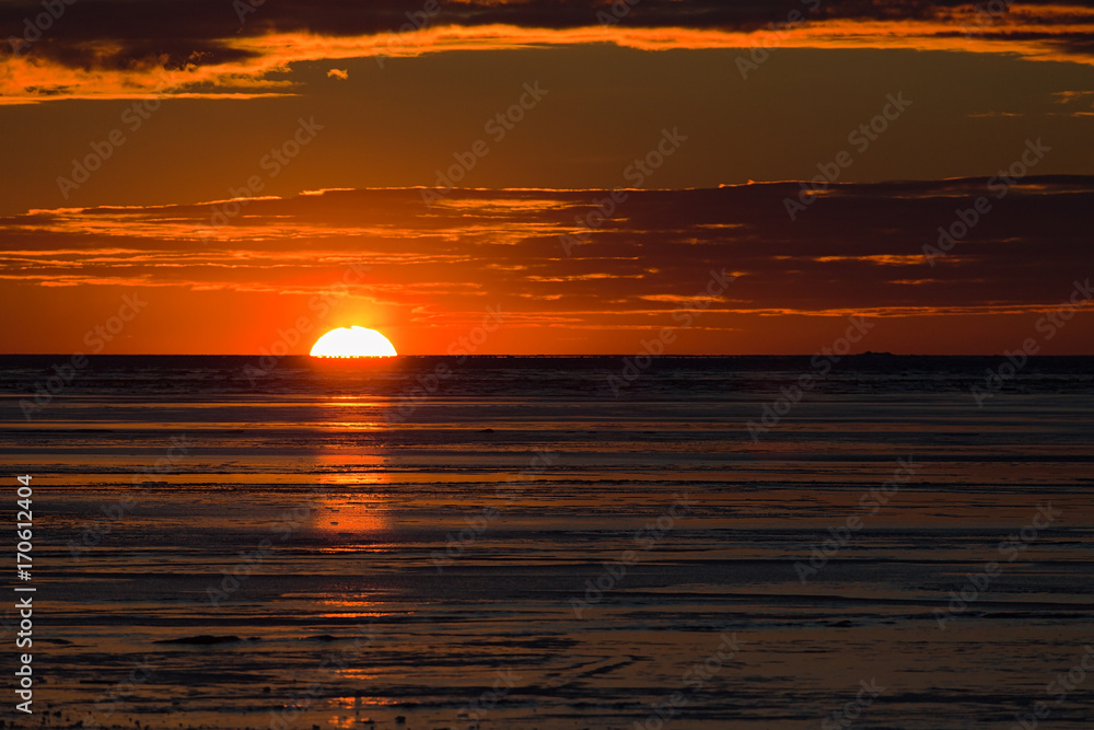 Sunset over a frozen harbor in rural Prince Edward Island, Canada.