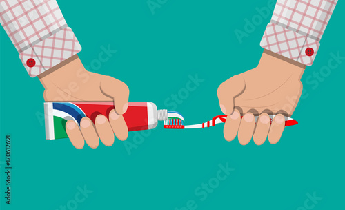 Toothbrush, toothpaste in hand. Brushing teeth.
