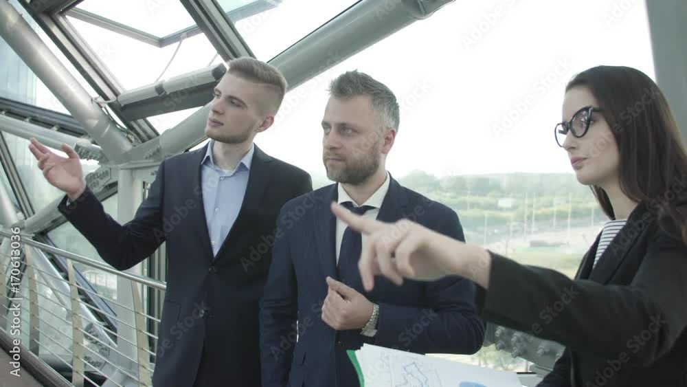 team of three businessmen in business center team of three businessmen in business center