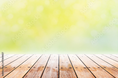 Empty wooden table with party in garden background blurred. wooden table border with blurred beautiful golden background.