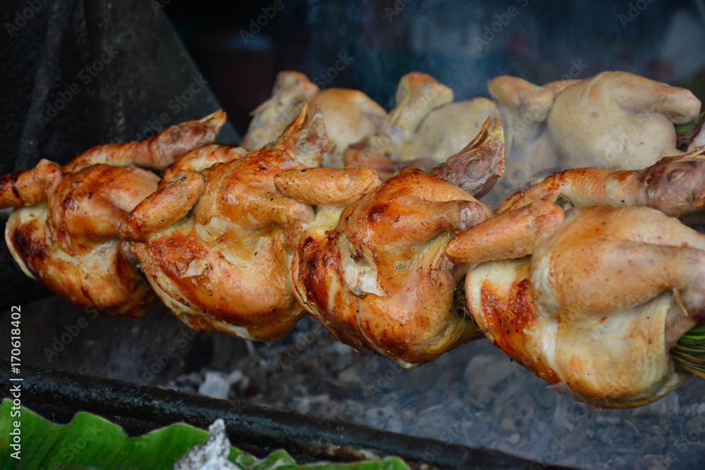 Close up grilled whole chicken on stove