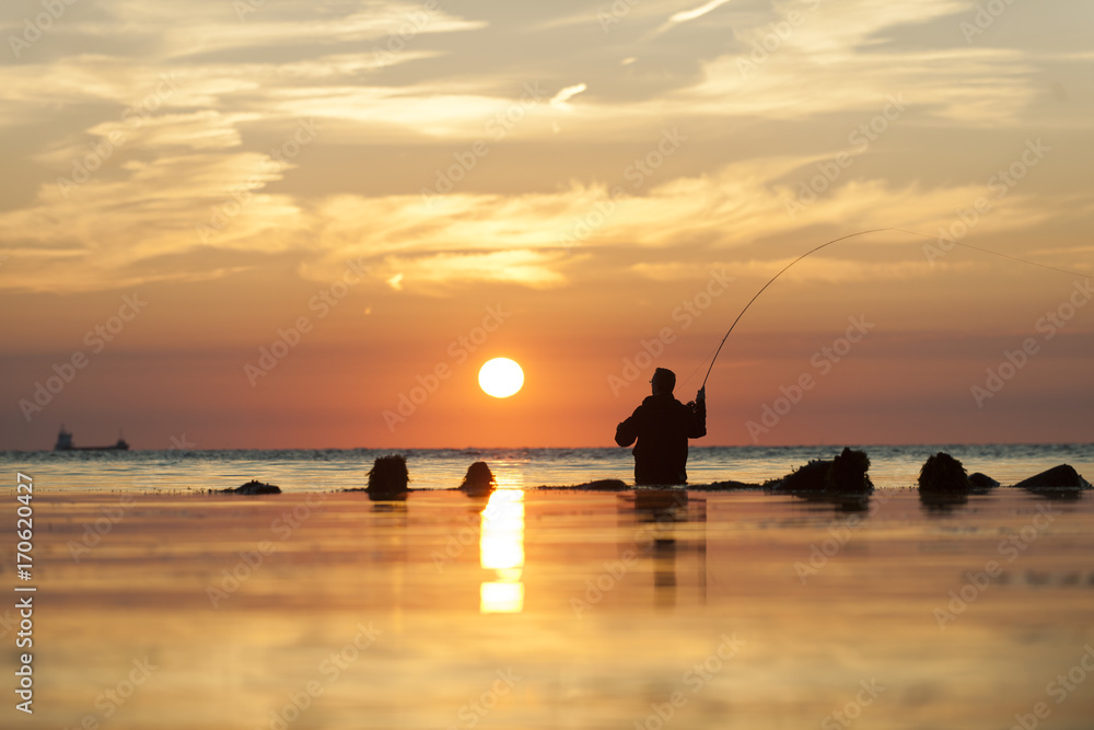 Fototapeta premium flyfishing man at dawn