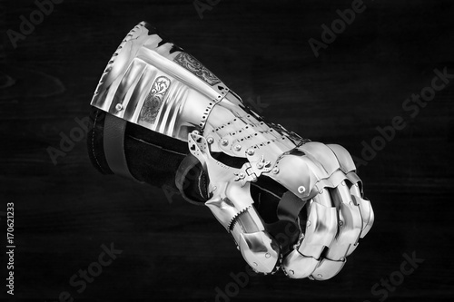 Medieval metal glove, detail of part of ancient armor photo
