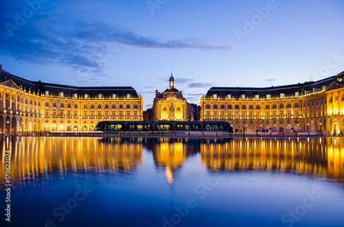 Reflection at blue hour of the Bourse Place with tramway in Bordeaux