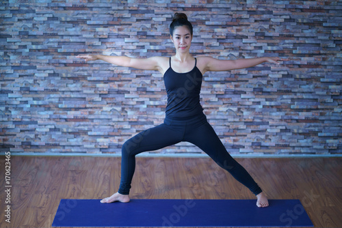 Women asian doing yoga stretching exercise in the studio.