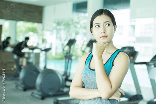 Asian Beautiful Woman Thinking Somthing at Gym, Woman Exercise at Gym Concept.