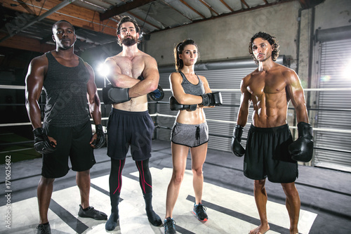 Gritty strong powerful portrait of diverse fighting mma trainers ready to intimidate and motivate