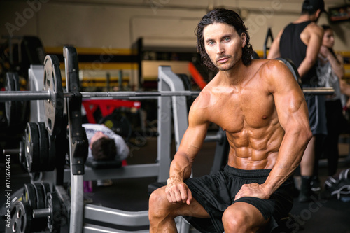 Portrait of a man relaxed during bodybuilding exercise fitness routine looking dramatic and sexy