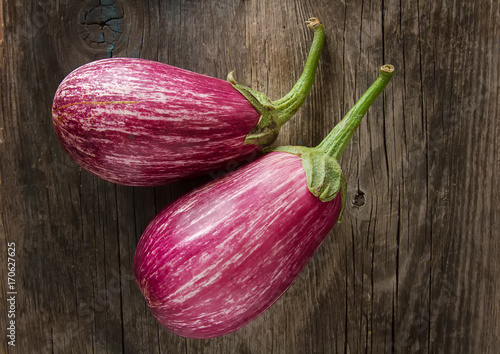Healthy and tasty purple eggplants on a dark background& Top view