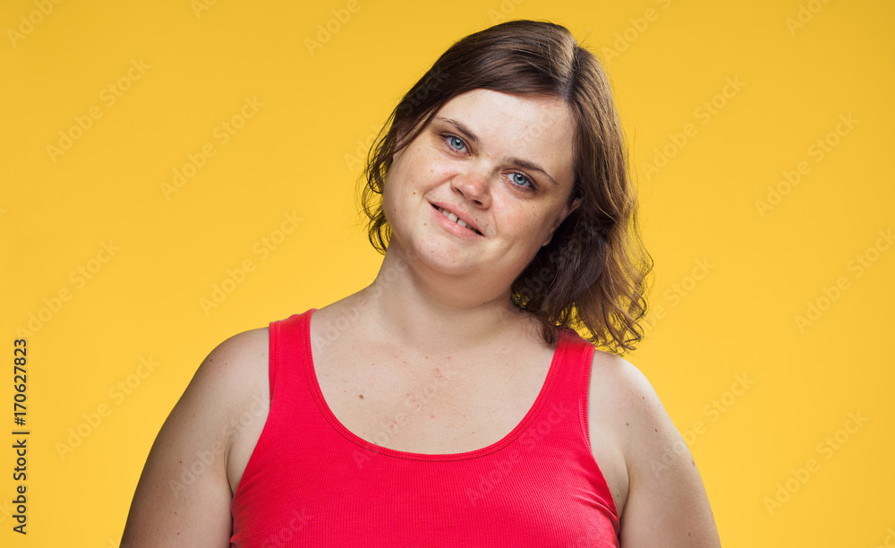 fat woman on a yellow background, portrait, smile fat woman on a yellow background, portrait, smile