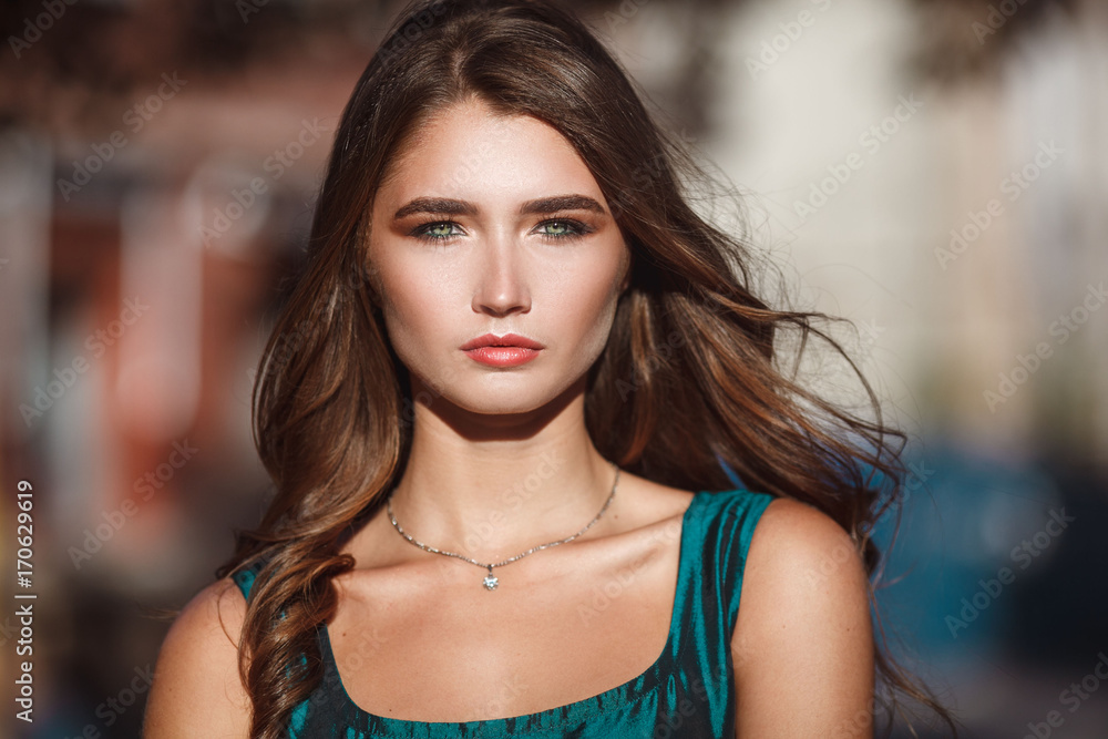 Close up portrait of young beautiful woman outside. Elegant lady with green eyes. Hot summer day. Close up portrait of young beautiful woman outside. Elegant lady with green eyes. Hot summer day.