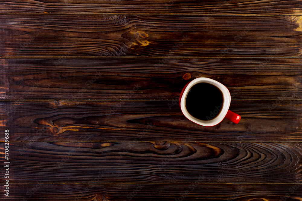 Fototapeta Cup of coffee on wooden table, top view