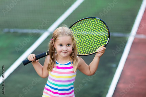 Child playing tennis on outdoor court © famveldman