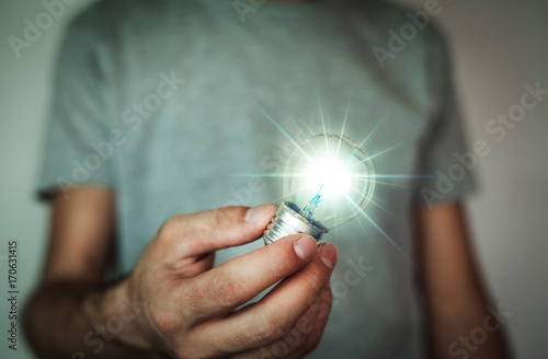 Man holding light bulb.
