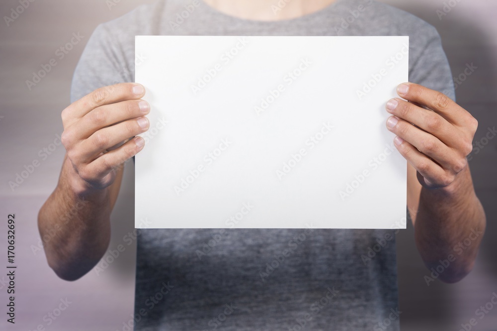 Composite image of midsection of man holding cardboard Composite image of midsection of man holding cardboard