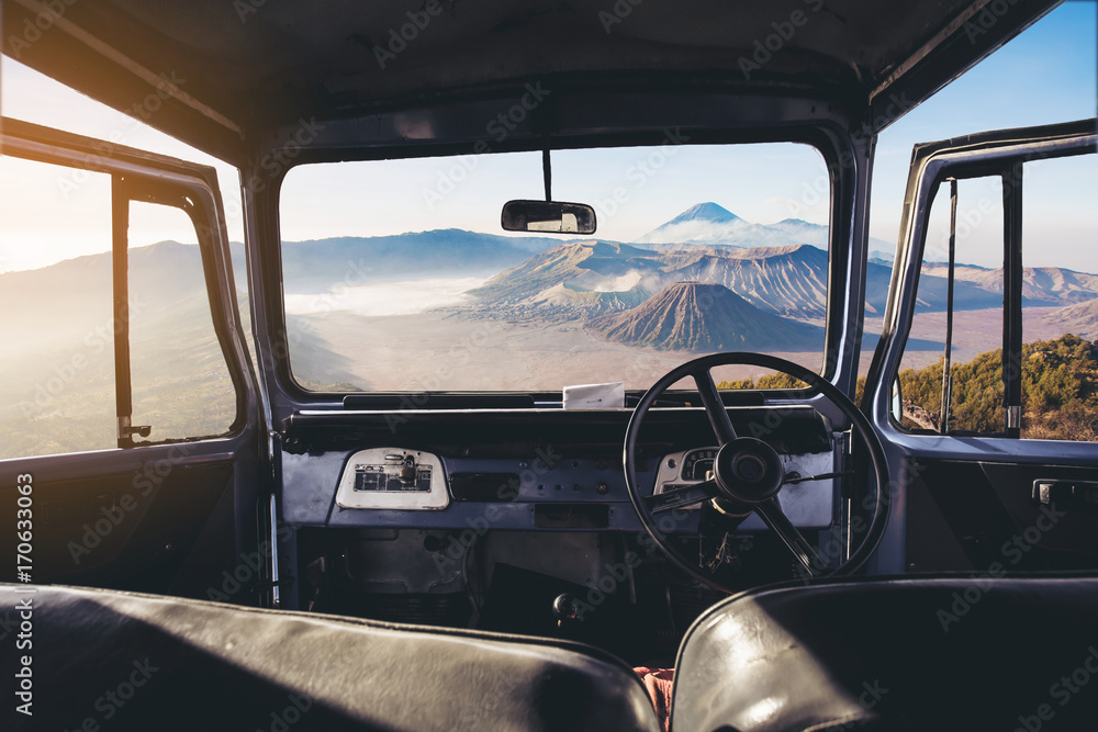 View on the dashboard of the car. Bromo mountains is in front of the car. View on the dashboard of the car. Bromo mountains is in front of the car.