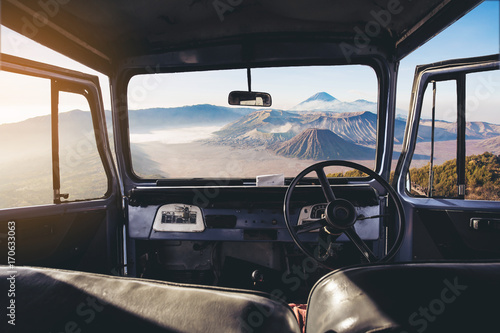View on the dashboard of the car. Bromo mountains is in front of the car. © Khritthithat