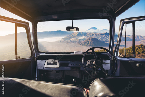 View on the dashboard of the car. Bromo mountains is in front of the car.