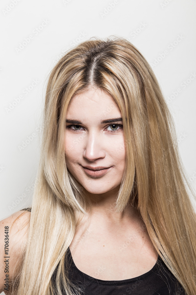 Close-up portrait of a young beautiful blonde girl on a light background. A woman with different emotions on her face. Close-up portrait of a young beautiful blonde girl on a light background. A woman with different emotions on her face.