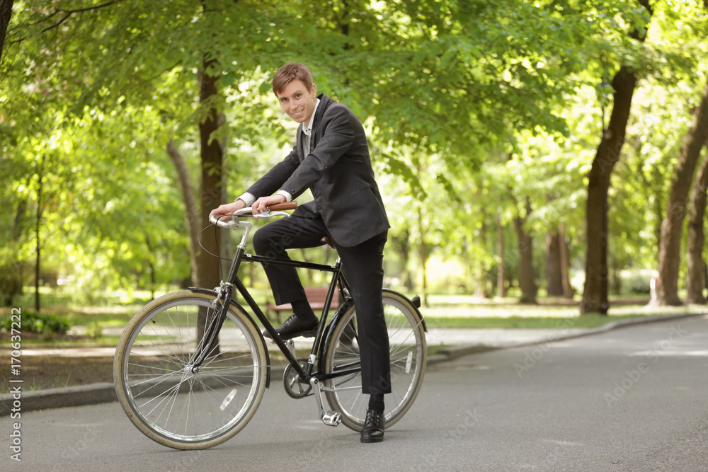 Young handsome businessman with bicycle outdoors on sunny day Young handsome businessman with bicycle outdoors on sunny day